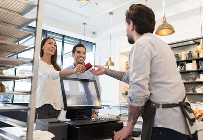 in a commercial retail space for lease in Vancouver, customers pay for a transaction at the counter